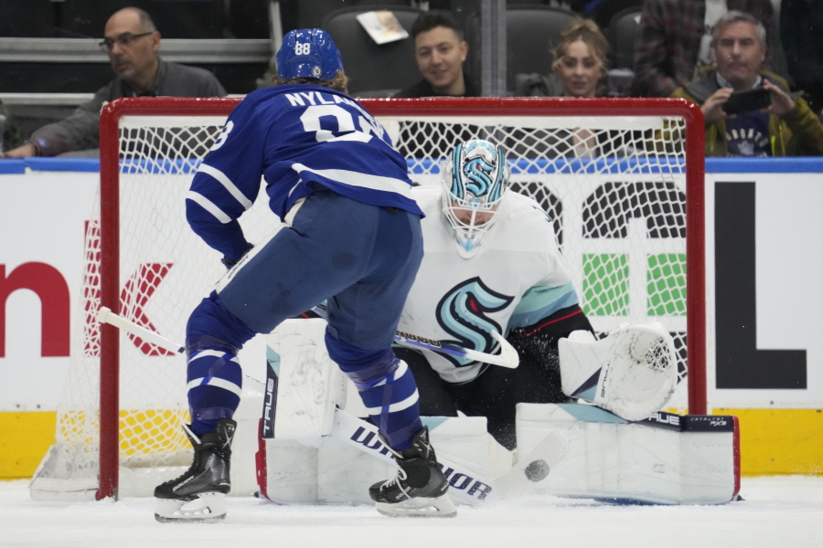Seattle Kraken goaltender Martin Jones (30) stops Toronto Maple Leafs right wing William Nylander (88) during the first period of an NHL hockey game Thursday, Jan. 5, 2023, in Toronto.