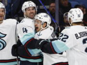 Seattle Kraken center Yanni Gourde (37) celebrates his goal with defenseman Justin Schultz (4) during the second period of an NHL hockey game against the Buffalo Sabres, Tuesday, Jan. 10, 2023, in Buffalo, N.Y. (AP Photo/Jeffrey T.