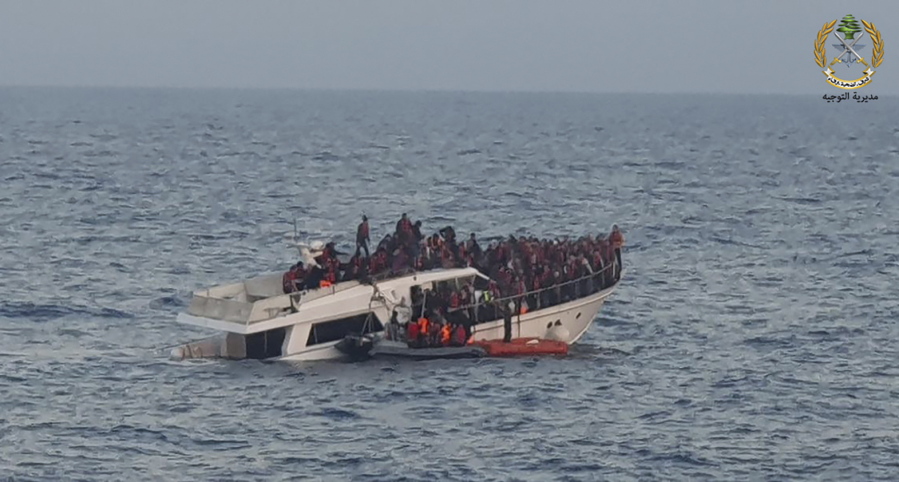 File In this photo released by the Lebanese Army, shows Lebanese army on their dinghy, rescuing migrants from a boat sinking in the Mediterranean Sea, near the shores of Tripoli, north Lebanon, Saturday, Dec. 31, 2022. A short Lebanese army statement said the vessel was carrying people "who were trying to illegally leave Lebanon's territorial waters." It said three Lebanese navy boats and one from the U.N. peacekeeping force in Lebanon, known as UNIFIL, were rescuing the approximately 200 migrants.