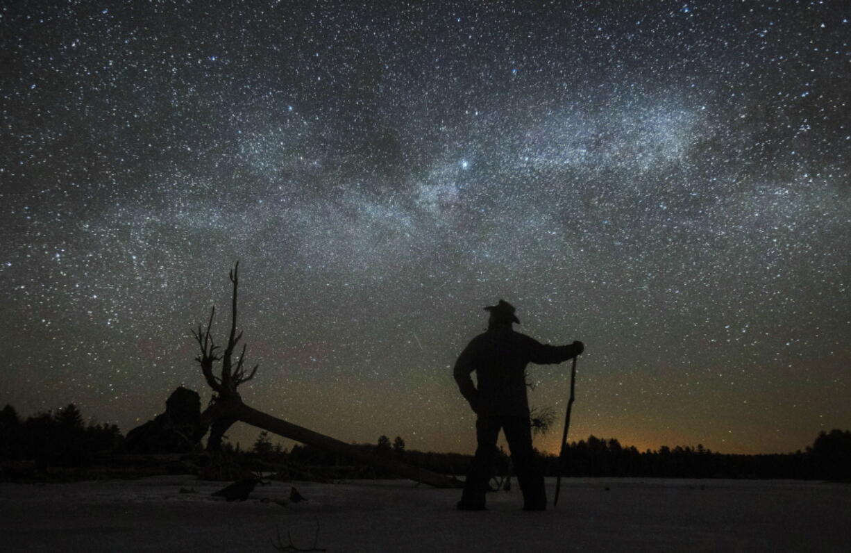 Dave Cooke observes the Milky Way over a frozen fish sanctuary in central Ontario, Canada,  early March 21, 2022. According to research published in the journal Science on Thursday, every year the night sky grows brighter, and the stars look dimmer.