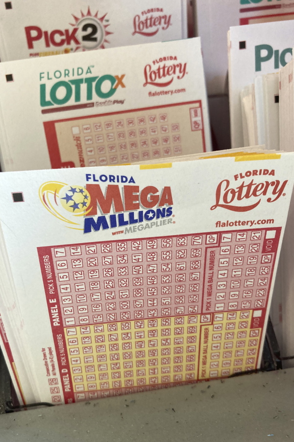 Mega Millions lottery playing slips are shown at a supermarket kiosk, Monday, Jan. 2, 2023, in Surfside, Fla. The jackpot for the Tuesday drawing is estimated at $785 million.