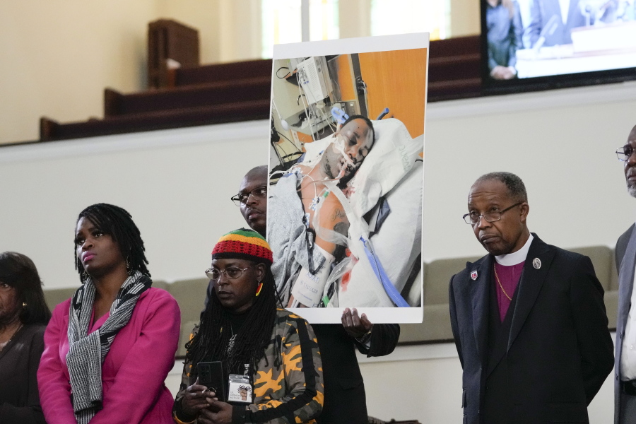 FILE - Family members and supporters hold a photograph of Tyre Nichols at a news conference in Memphis, Tenn., Jan. 23, 2023. The U.S. Attorney's Office said Wednesday, Jan. 25, 2023 the federal investigation into the death of a Black man who died after a violent arrest by Memphis police "may take some time." Speaking during a news conference, U.S. Attorney Kevin G. Ritz said his office is working with the Justice Department's Civil Rights Division in Washington as it investigates the case of Tyre Nichols, who died three days after his Jan. 7 arrest.