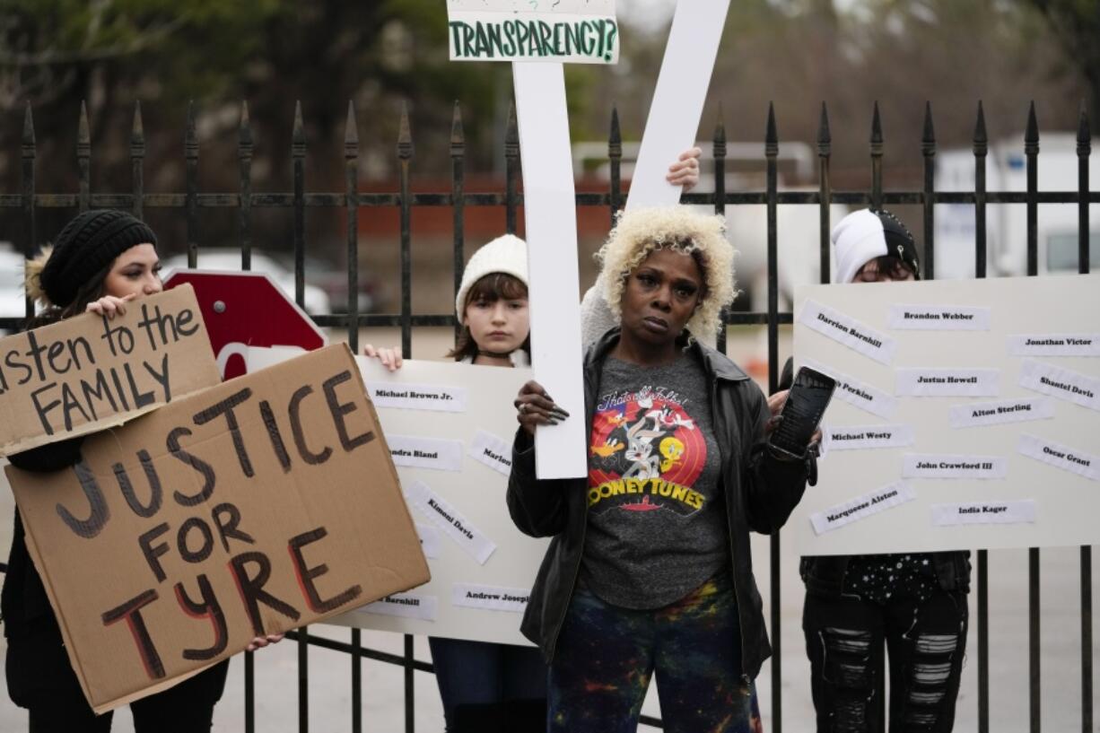 A group of demonstrators protest outside a police precinct in response to the death of Tyre Nichols, who died after being beaten by Memphis police officers, in Memphis, Tenn., Sunday, Jan. 29, 2023.