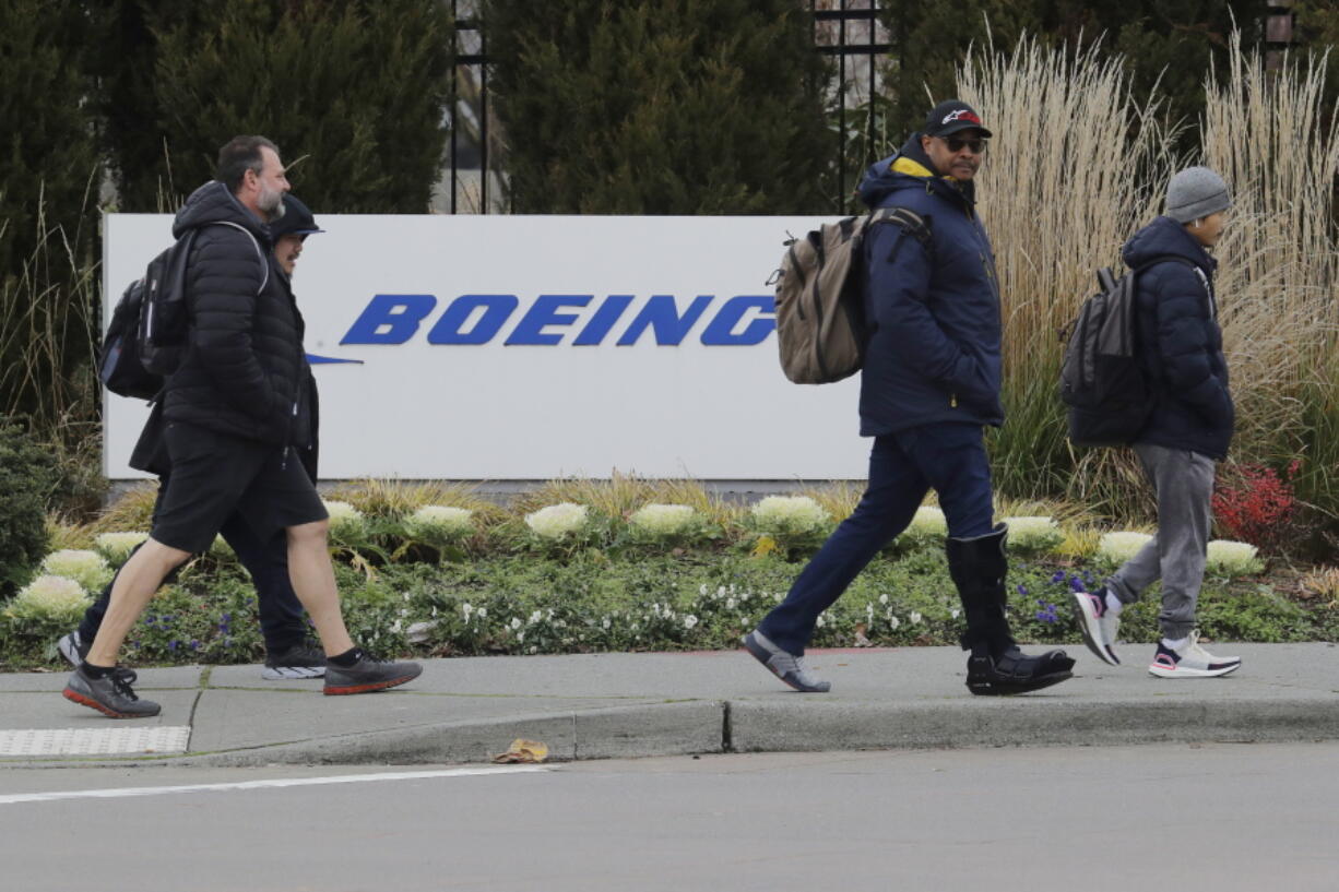 FILE - Workers walk past a Boeing Co. sign as they leave the factory where the company's 737 Max airplanes are built, Dec. 17, 2019, in Renton, Wash. U.S. accident investigators gave more details Tuesday, Jan. 24, 2023, about what they think caused a Boeing plane to crash in Ethiopia in 2019. The U.S. National Transportation Safety Board said that a sensor which gave false readings about the plane was damaged by striking a foreign object, most likely a bird, which conflicts with a finding by Ethiopian officials. (AP Photo/Ted S.