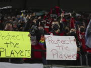 FILE - Portland Thorns fans hold signs during the first half of the team's National Women's Soccer League soccer match against the Houston Dash in Portland, Ore., Oct. 6, 2021. An investigation commissioned by the NWSL and its players union found "widespread misconduct" directed at players dating back to the beginnings nearly a decade ago of the country's top women's professional league.