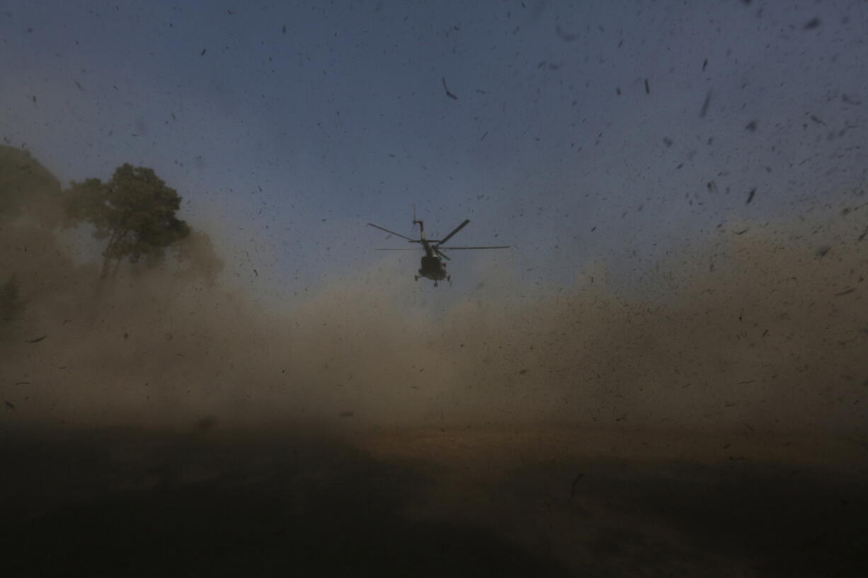 A helicopter carrying bodies of victims of a plane crash arrives in Kathmandu, Nepal, Tuesday, Jan. 17, 2023. Nepalese authorities on Tuesday began returning to families the bodies of victims of a flight that crashed Sunday, and said they were sending the aircraft's data recorder to France for analysis as they try to determine what caused the country's deadliest plane accident in 30 years.