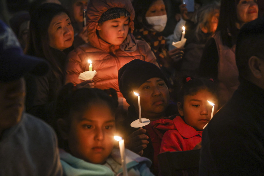 People gather at a community vigil for the Half Moon Bay shootings earlier in the week in Half Moon Bay, Calif., Friday, Jan. 27, 2023.