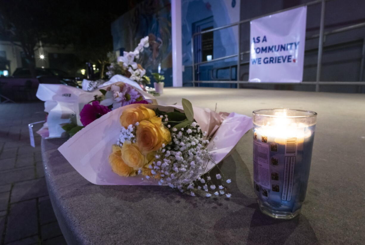 Flowers and candles lie at a memorial for victims of the mass shooting a day earlier, in Half Moon Bay, Calif., Tuesday, Jan. 24, 2023.