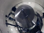 FILE - An inert Minuteman III missile is seen in a training launch tube at Minot Air Force Base, N.D., June 25, 2014. Nine military officers who had worked decades ago at a nuclear missile base in Montana, home to a vast field of 150 Minuteman III intercontinental ballistic missile silos, have been diagnosed with blood cancer and there are "indications" the disease may be linked to their service, according to military briefing slides obtained by The Associated Press. One of the officers has died.
