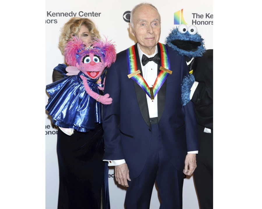 FILE - Honoree Lloyd Morrisett appears with muppet characters at the 42nd Annual Kennedy Center Honors at The Kennedy Center, Sunday, Dec. 8, 2019, in Washington. Morrisett, the co-creator of the beloved children's education TV series "Sesame Street," which uses empathy and fuzzy monsters like Abby Cadabby, Elmo and Cookie Monster to charm and teach generations around the world, has died. He was 93. Morrisett's death was announced Tuesday by Sesame Workshop, the nonprofit he helped establish under the name the Children's Television Workshop.