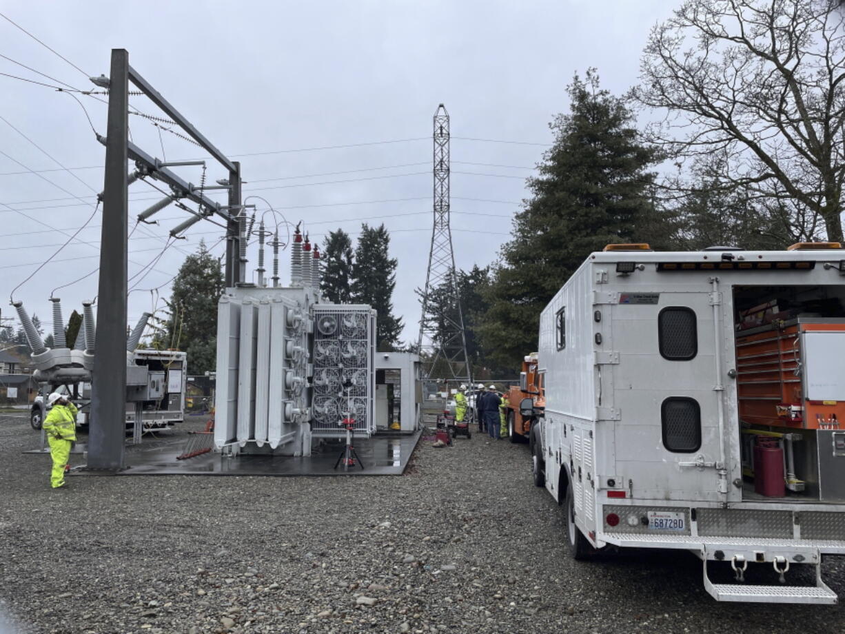 A Tacoma Power crew works at an electrical substation damaged by vandals early on Christmas morning after cutting a padlock to gain entry according to a crew manager, Sunday, Dec. 25, 2022 in Graham, Wa.
