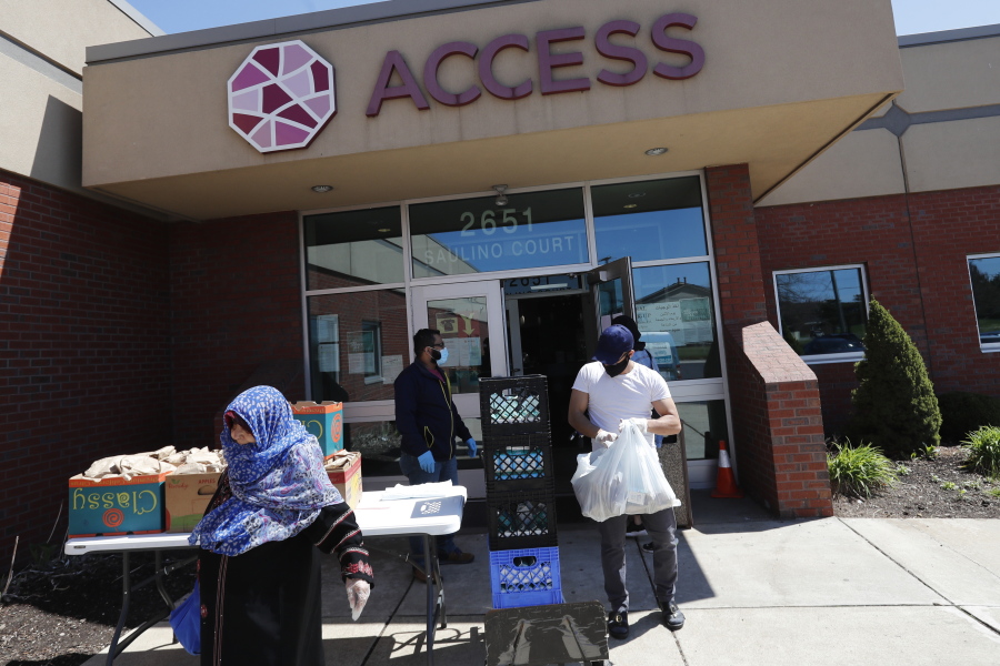 FILE - Workers at ACCESS, the Arab Community Center for Economic and Social Services, help with meals for the Arab community in Dearborn, Mich., on May 1, 2020. A Middle Eastern and North African category would be added to U.S. federal surveys and censuses, and changes would be made to how Hispanics are able to self-identify, under preliminary recommendations released Thursday, Jan. 26, 2023, by the Biden administration in what would be the first update to race and ethnicity standards in a quarter century.
