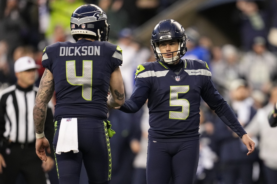 Seattle Seahawks place kicker Jason Myers (5) shakes hands with place holder Michael Dickson (4) after Myers' game-winning field goal in overtime of an NFL football game against the Los Angeles Rams Sunday, Jan. 8, 2023, in Seattle.