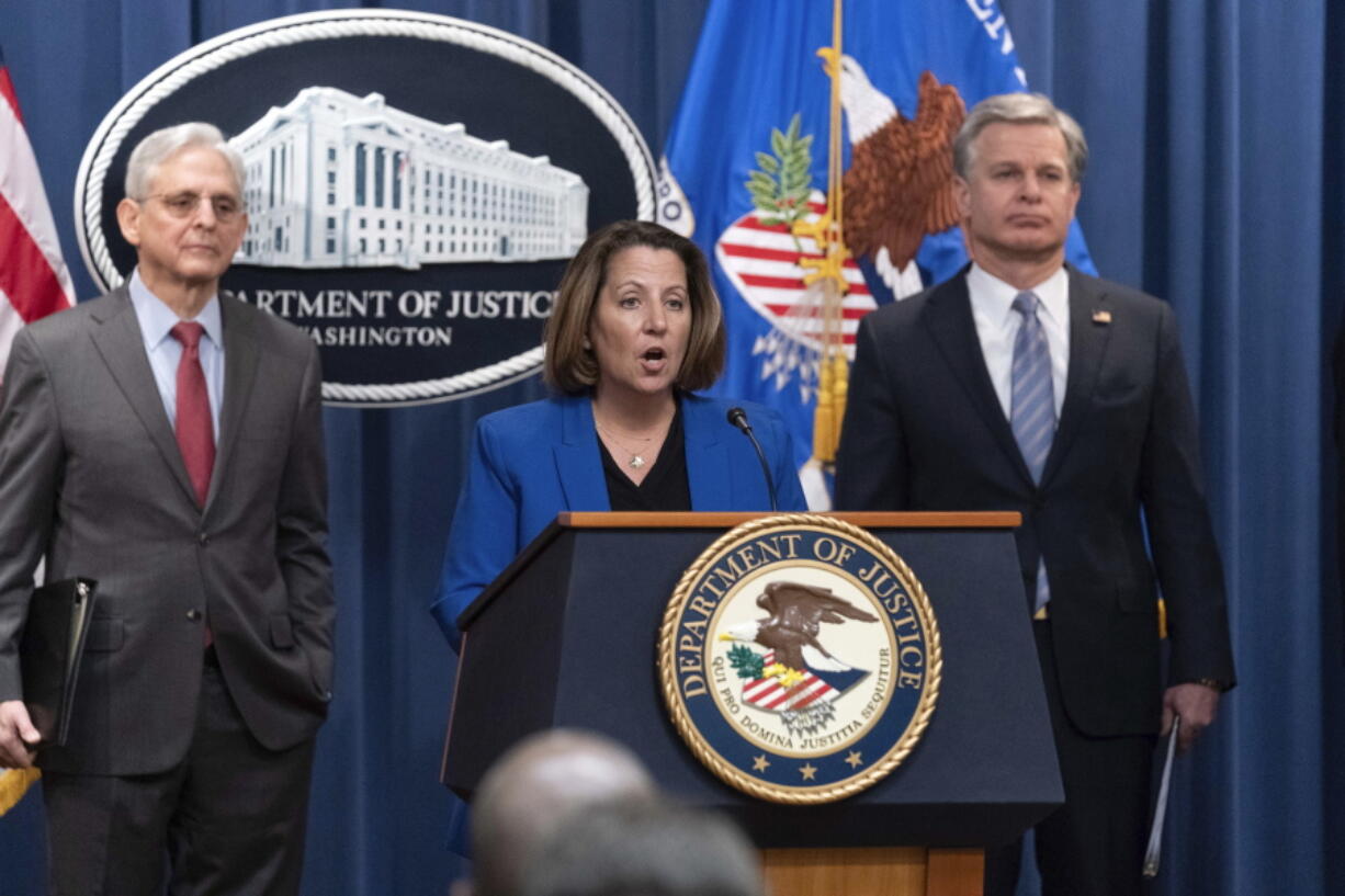 Deputy Attorney General Lisa Monaco flanked by Attorney General Merrick Garland, left, and Federal Bureau of Investigation (FBI) Director Christopher Wray speaks during a news conference to announce an international ransomware enforcement action, at the Department of Justice in Washington, Thursday, Jan. 26, 2023. The FBI has seized the website of a prolific ransomware gang that has heavily targeted hospitals and other healthcare providers.