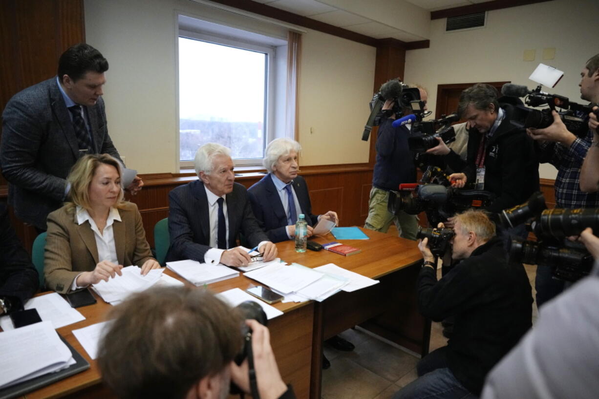 Members of the Moscow Helsinki Group and their lawyers talk with journalists in the courtroom before a hearing on the lawsuit to liquidate the Moscow Helsinki Group in Moscow, Russia, Wednesday, Jan. 25, 2023. The Moscow Helsinki Group is one of the country's oldest human rights organizations.