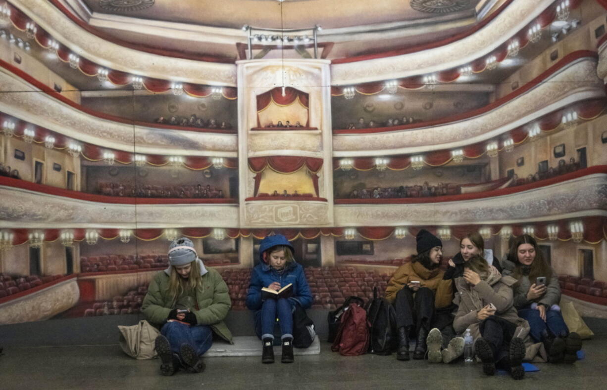 People gather in a subway station being used as a bomb shelter during a Russian rocket attack in Kyiv, Ukraine, Thursday, Jan. 26, 2023.