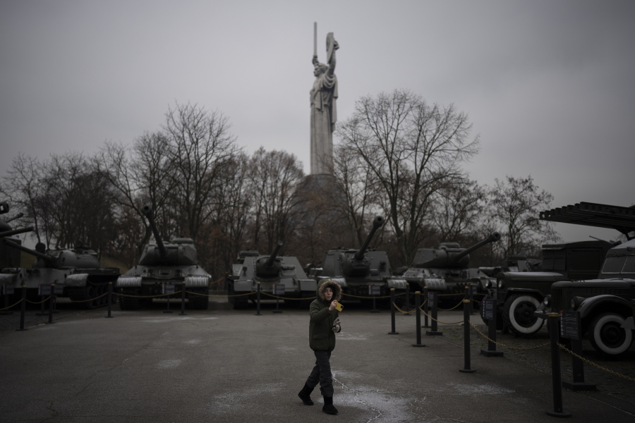A boy takes pictures of old tanks on display at a war museum in Kyiv, Ukraine, Wednesday, Jan. 25, 2023.