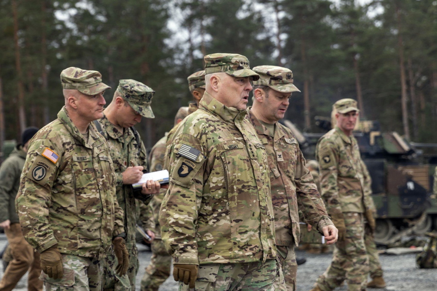 In this image provided by the U.S. Army, U.S. Chairman of the Joint Chiefs of Staff Gen. Mark Milley meets with U.S. Army leaders responsible for the collective training of Ukrainians at Grafenwoehr Training Area, Grafenwoehr, Germany, on Monday, Jan. 16, 2023. At left is Brig. Gen. Joseph E. Hilbert, who is the commanding general for the 7th Army Training Command. Milley visited the training site in Germany for Ukrainian forces and met with troops and commanders.(Staff Sgt. Jordan Sivayavirojna/U.S.