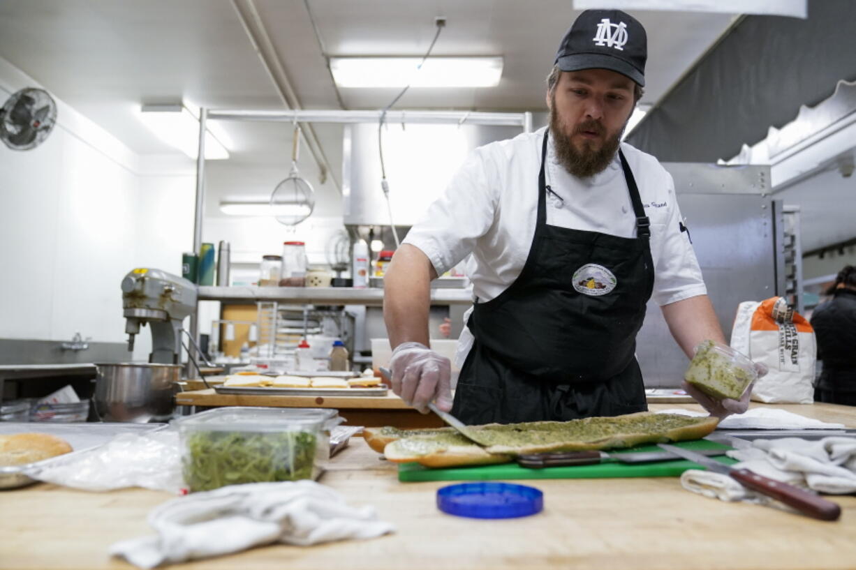 Chef Josh Gjersand prepares a sandwich for Mount Diablo High School students to try during a taste test in Concord, Calif., Friday, Jan. 13, 2023. The school district in suburban San Francisco has been part of a national "farm-to-school" movement for years, where schools try to buy as much locally as possible. But the mission has been kicked into higher gear with a California program that provides free meals to all public school students in the state, along with unprecedented new funding. (AP Photo/Godofredo A. V?squez) (Godofredo A.