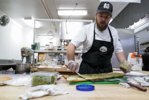 Chef Josh Gjersand prepares a sandwich for Mount Diablo High School students to try during a taste test in Concord, Calif., Friday, Jan. 13, 2023. The school district in suburban San Francisco has been part of a national "farm-to-school" movement for years, where schools try to buy as much locally as possible. But the mission has been kicked into higher gear with a California program that provides free meals to all public school students in the state, along with unprecedented new funding. (AP Photo/Godofredo A. V?squez) (Godofredo A.