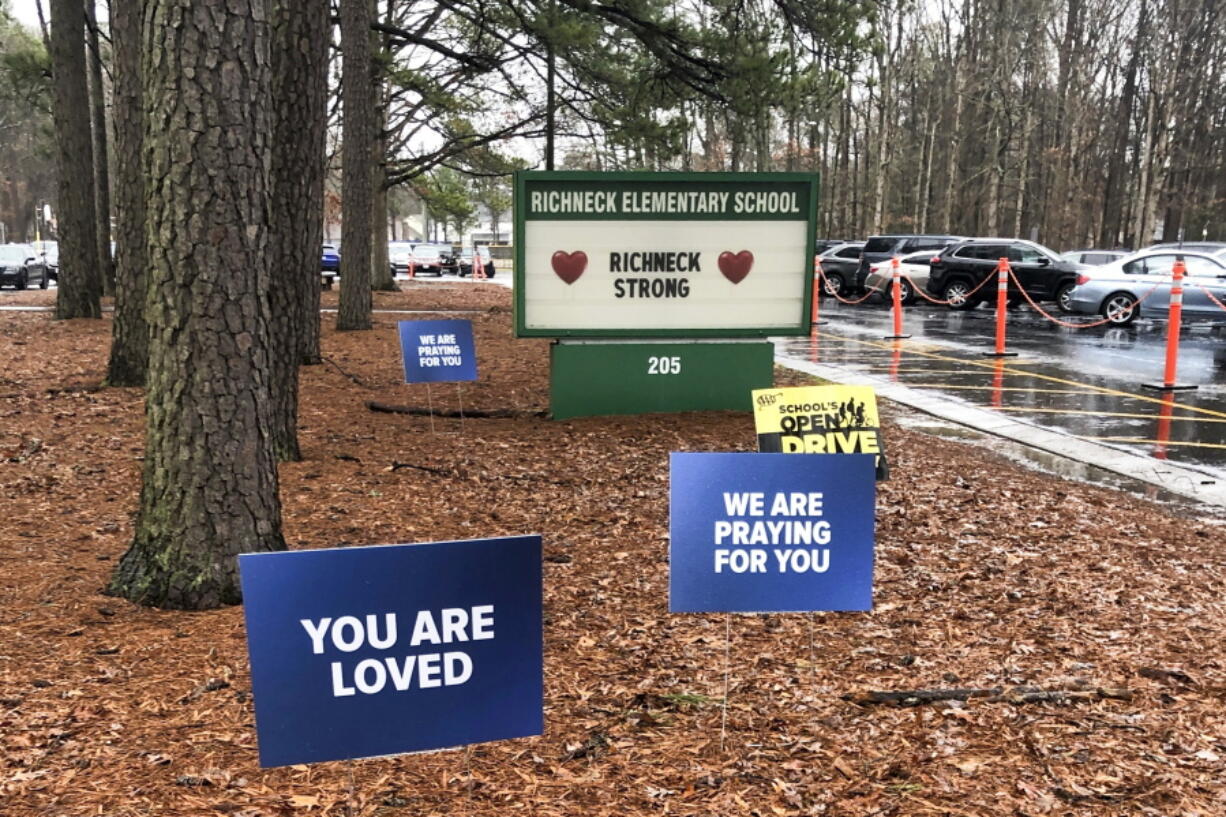 FILE - Signs stand outside Richneck Elementary School in Newport News, Va., on Jan. 25, 2023. The school is set to reopen Monday, Jan. 30, more than three weeks after a Jan. 6 shooting. Police have said a boy brought a 9mm handgun to school and intentionally shot his teacher, Abby Zwerner, as she was teaching her first-grade class.