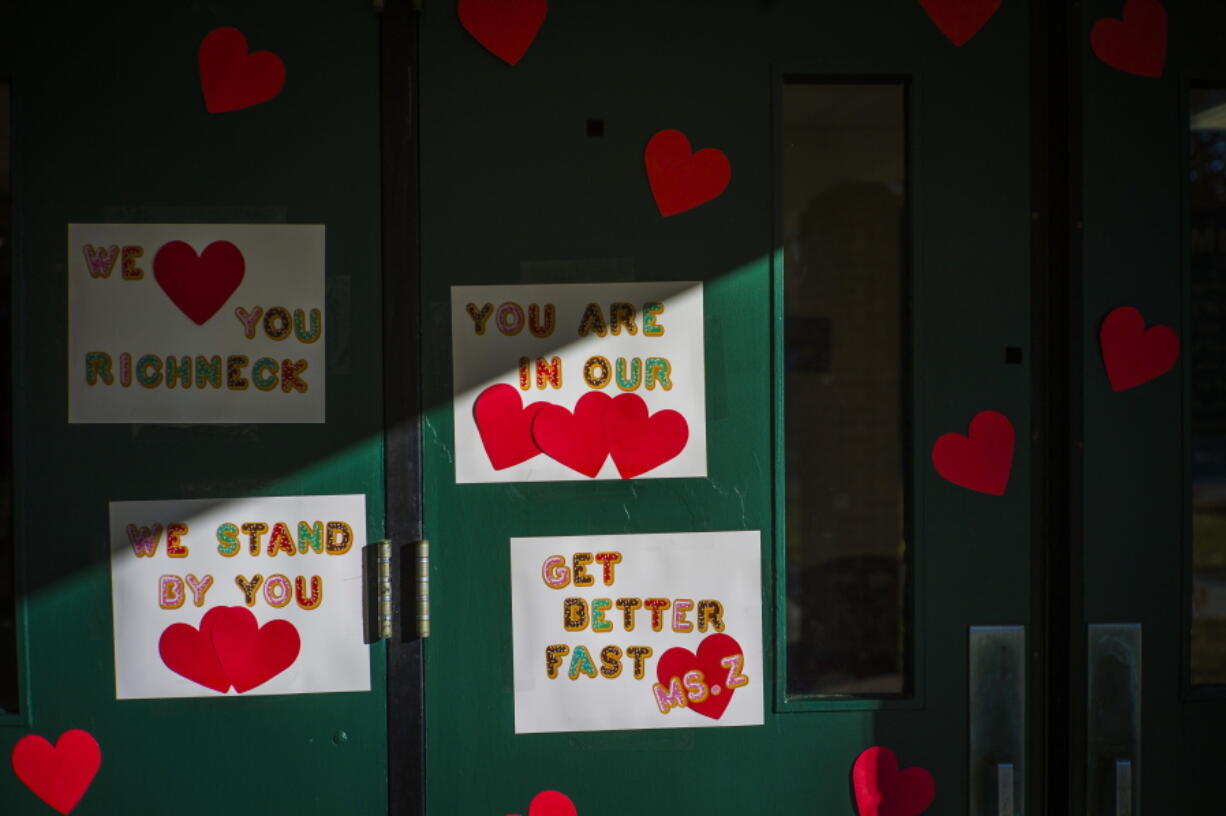 FILE - Messages of support for teacher Abby Zwerner, who was shot by a 6-year-old student, grace the front door of Richneck Elementary School Newport News, Va., on Jan. 9, 2023. According to a Tuesday, Jan. 24, 2023, media advisory, the first-grade teacher from Virginia who was shot and seriously wounded by a 6-year-old student, has hired a trial attorney to represent her. (AP Photo/John C.