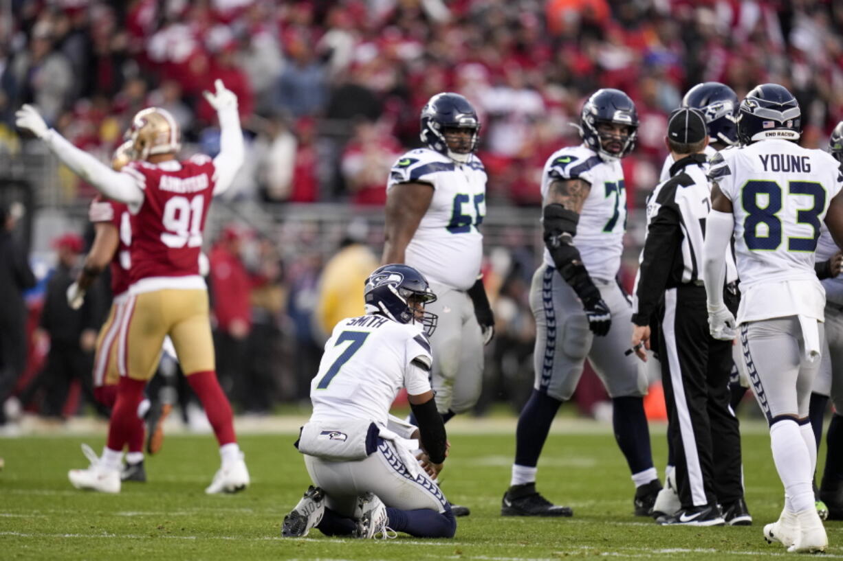 Seattle Seahawks quarterback Geno Smith (7) reacts after losing a fumble against the San Francisco 49ers during the second half of an NFL wild card playoff football game in Santa Clara, Calif., Saturday, Jan. 14, 2023. (AP Photo/Godofredo A.