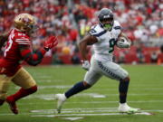 Seattle Seahawks running back Kenneth Walker III (9) runs for a touchdown against San Francisco 49ers linebacker Dre Greenlaw (57) during the first half of an NFL wild card playoff football game in Santa Clara, Calif., Saturday, Jan. 14, 2023.