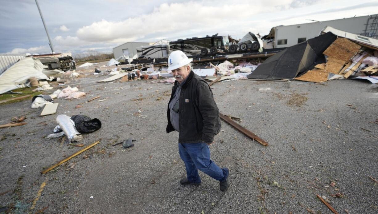 Johnny Graham walks past his storm-damaged office Tuesday in Pasadena, Texas. (David J.