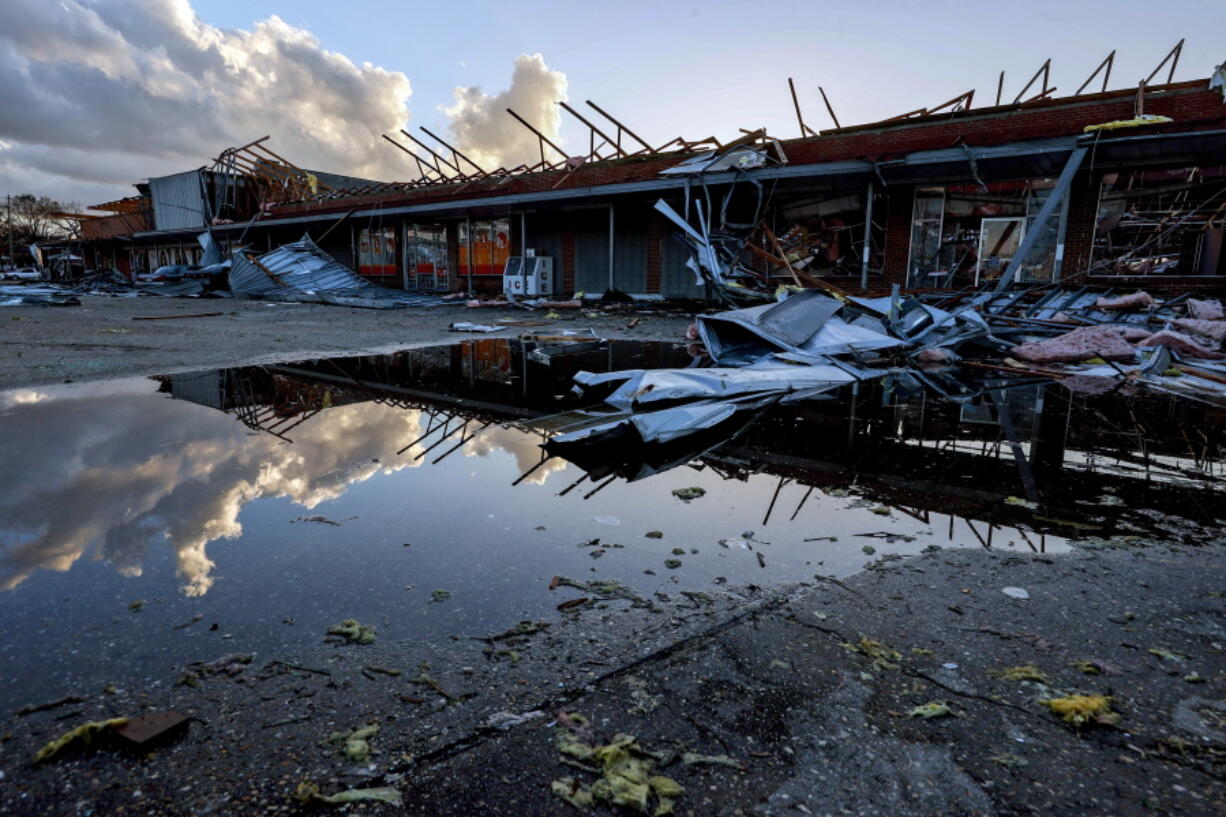 The roof of a local businesses is strewn about after a tornado passed through Selma, Ala., Thursday, Jan. 12, 2023.