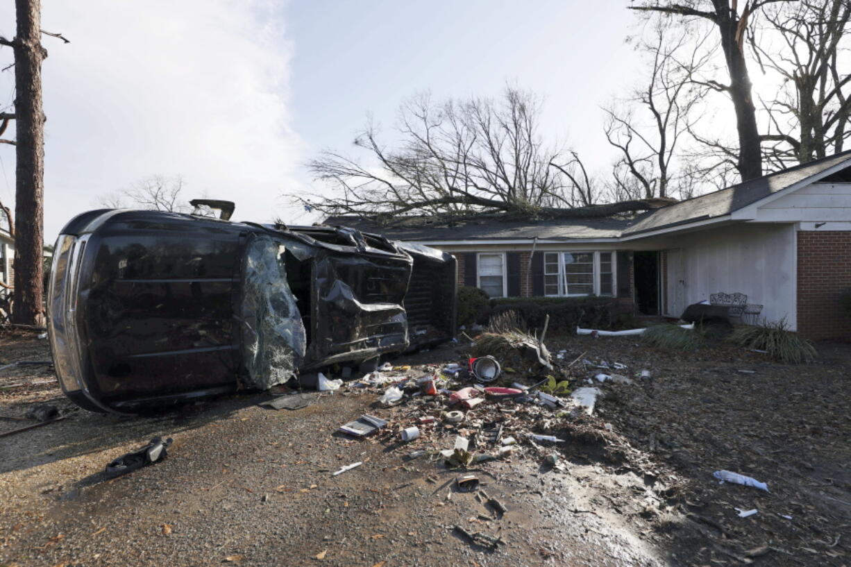 A vehicle is upended and debris is strewn about follow a tornado near Meadowview elementary school Wednesday, Jan. 12, 2023 in Selma Ala.