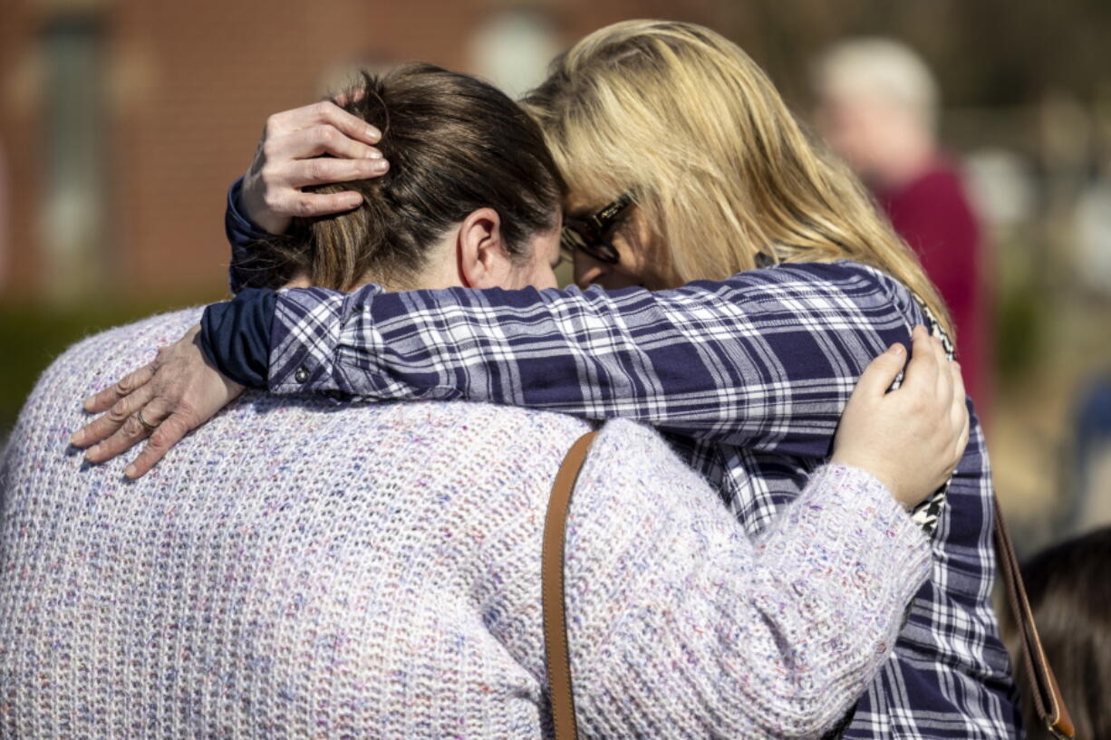 Kerry Fulford, right, embraces Shana Latham, offering words of comfort at Crosspoint Christian Church following a tornado several days earlier in Selma, Ala., Sunday, Jan. 15, 2023. Latham was one of the teachers who acted quickly to move children into safe interior rooms as the tornado caused heavy damage at the church's preschool building.