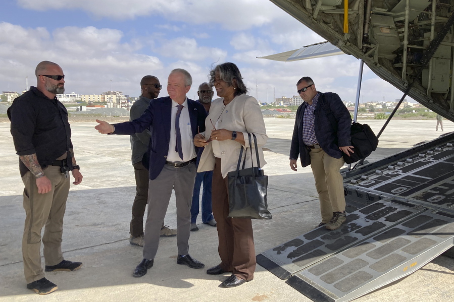 The U.S. ambassador to the United Nations, Linda Thomas-Greenfield, center, is welcomed by U.S. ambassador to Somalia Larry Andre, center left, on her arrival in Mogadishu, Somalia Sunday, Jan. 29, 2023. The first U.S.