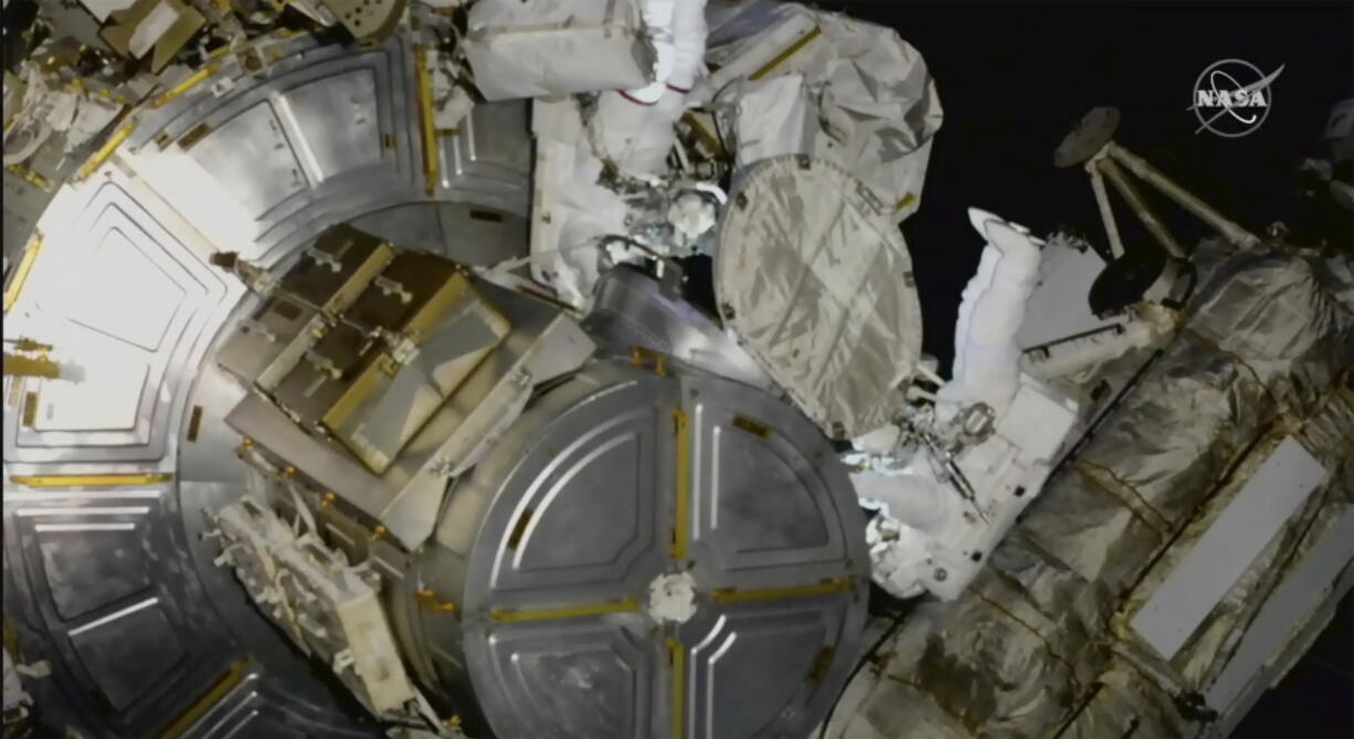 This photo provided by NASA, astronauts NASA's Nicole Mann and Japan's Koichi Wakata venture out on a spacewalk at the International Space Station on Friday, Jan. 20, 2023.  Their job was to install support struts for small solar panels launching this summer, part of a continuing effort by NASA to expand the space station's power grid.