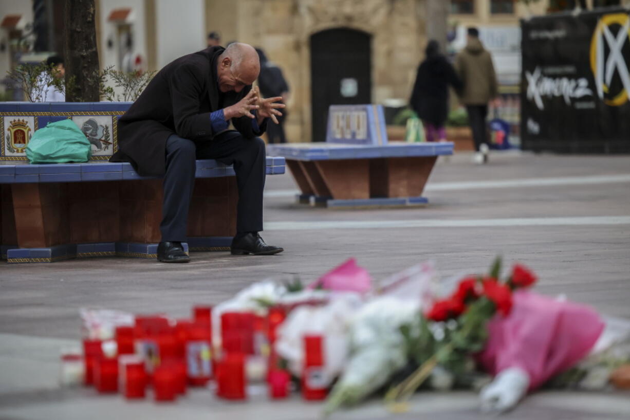 A man reacts next to a memorial site for a church sacristan who was killed Wednesday in Algeciras, southern Spain, Thursday, Jan. 26, 2023. Residents of the Spanish city of Algeciras recounted their shock after a machete-wielding attacker jumped on the altar of a church before chasing a victim into a city square and inflicting mortal wounds. The attacks on two churches by a single assailant on Wednesday night have shaken the city near the southern tip of Spain across from a bay from Gibraltar.