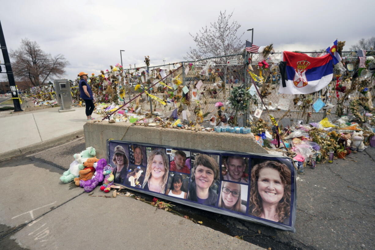 FILE - Tributes cover the temporary fence around the King Soopers grocery store in which 10 people died in a mass shooting in late March on Friday, April 23, 2021, in Boulder, Colo. A judge is scheduled to hold a hearing Friday, Jan. 27, 2023 to discuss whether a man charged with killing 10 people at a Colorado supermarket nearly two years ago is mentally competent to stand trial.