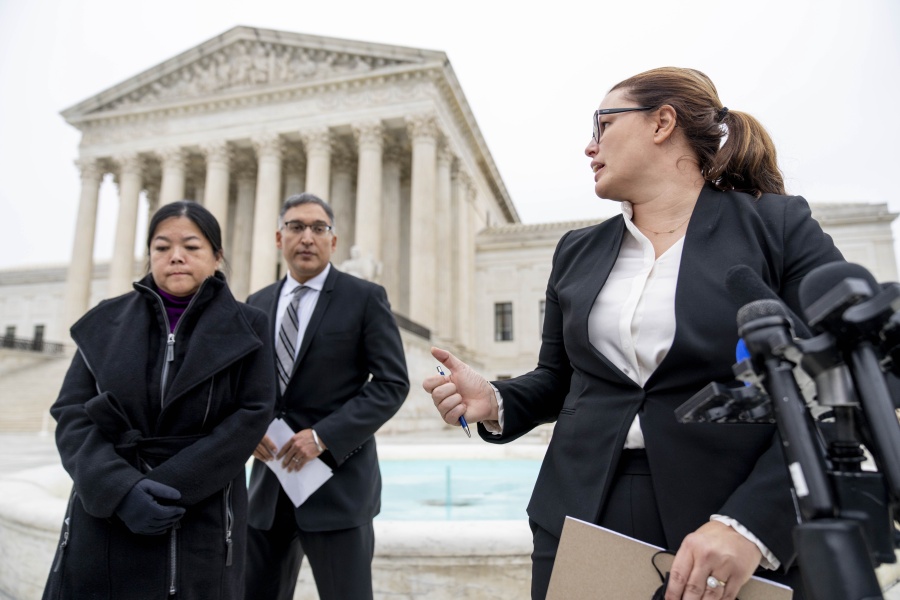 Attorney Allison Riggs, accompanied by attorney Neal Katyal, center, and Common Cause National Redistricting Director Kathay Feng, left, speaks in front of the Supreme Court in Washington, Wednesday, Dec. 7, 2022, as the Court hears arguments on a new elections case that could dramatically alter voting in 2024 and beyond. The case is from highly competitive North Carolina, where Republican efforts to draw congressional districts heavily in their favor were blocked by a Democratic majority on the state Supreme Court.