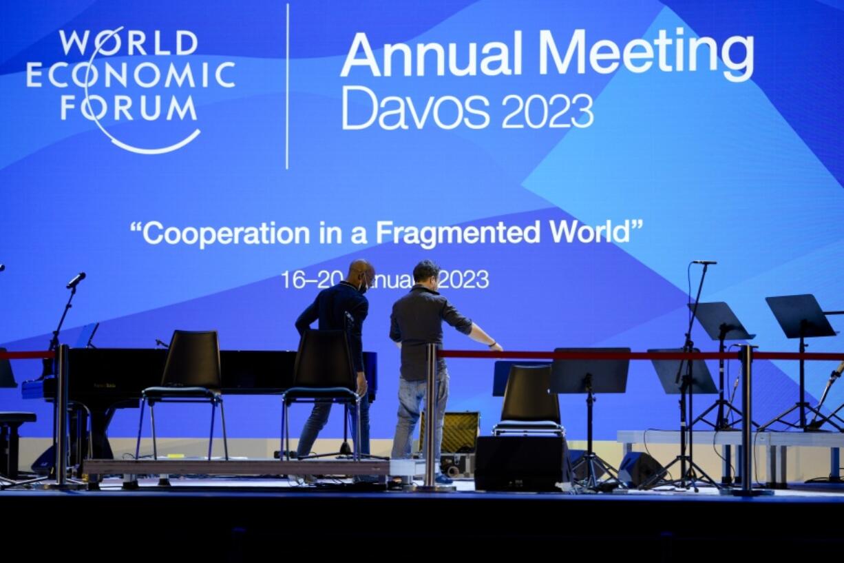 People set up the stage at the eve of the opening of the World Economic Forum in Davos, Switzerland, Sunday, Jan. 15, 2023. The annual meeting of the World Economic Forum is taking place in Davos from Jan. 16 until Jan. 20, 2023.
