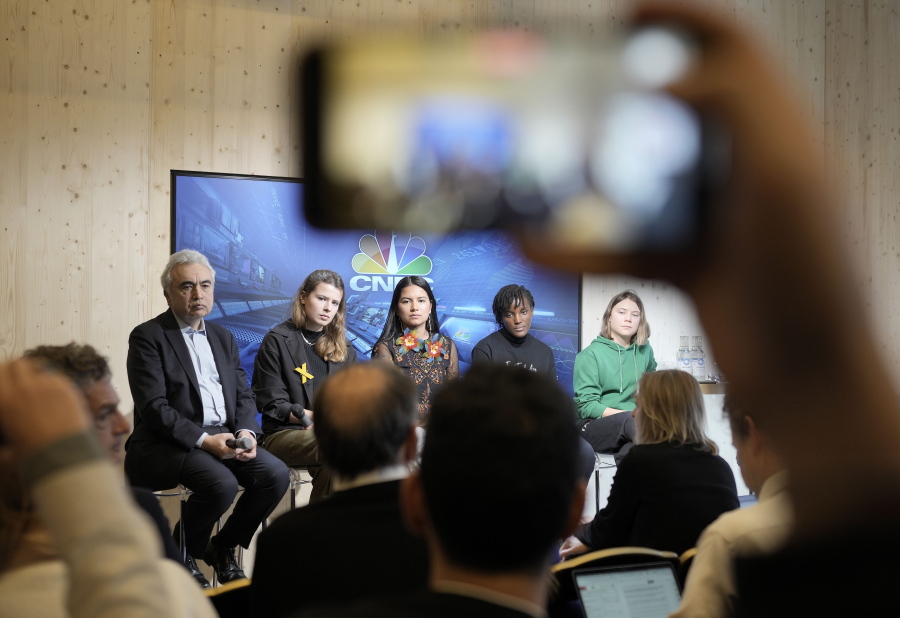 People making photos with their phones of climate activists Greta Thunberg of Sweden, Vanessa Nakate of Uganda, Helena Gualinga of Ecuador, Luisa Neubauer of Germany, and Fatih Birol, Head of the International Energy Agency, from right, at a press conference at the World Economic Forum in Davos, Switzerland Thursday, Jan. 19, 2023. The annual meeting of the World Economic Forum is taking place in Davos from Jan. 16 until Jan. 20, 2023.