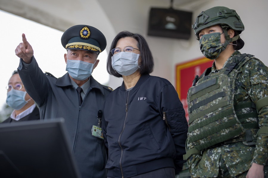 In this photo released by the Taiwan Presidential Office, Taiwan's President Tsai Ing-wen, center, inspects a military drills at a military base in Chiayi, southwestern Taiwan, Friday, Jan. 6, 2023. President Tsai visited a military base Friday to observe drills while rival China protested the passage of a U.S. Navy destroyer through the Taiwan Strait, as tensions between the sides showed no sign of abating in the new year.