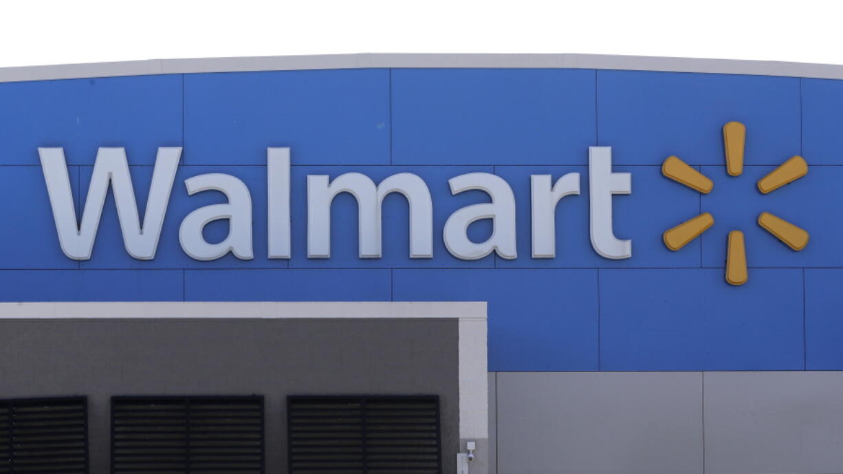 FILE - A Walmart logo is displayed outside of a Walmart store, in Walpole, Mass, Sept. 3, 2019. A man opened fire on police inside an Indiana Walmart before he was shot and killed by officers late Thursday, Jan. 19, 2023, authorities said.