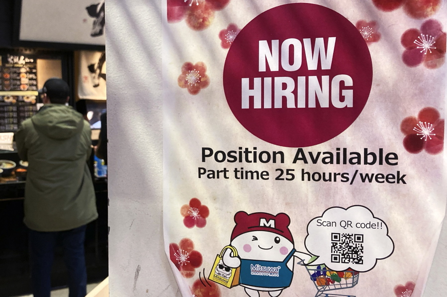 FILE - A hiring sign is displayed at a grocery store in Arlington Heights, Ill., Tuesday, Dec. 27, 2022. On Thursday, the Labor Department reports on the number of people who applied for unemployment benefits last week. (AP Photo/Nam Y.