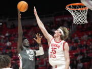 Utah center Branden Carlson (35) defends against Washington State forward Mouhamed Gueye (35) during the first half of an NCAA college basketball game Thursday, Jan. 19, 2023, in Salt Lake City.