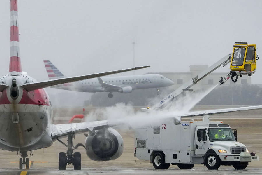 An American Airlines aircraft undergoes deicing procedures on Monday, Jan. 30, 2023, at Dallas/Fort Worth International Airport in Texas.