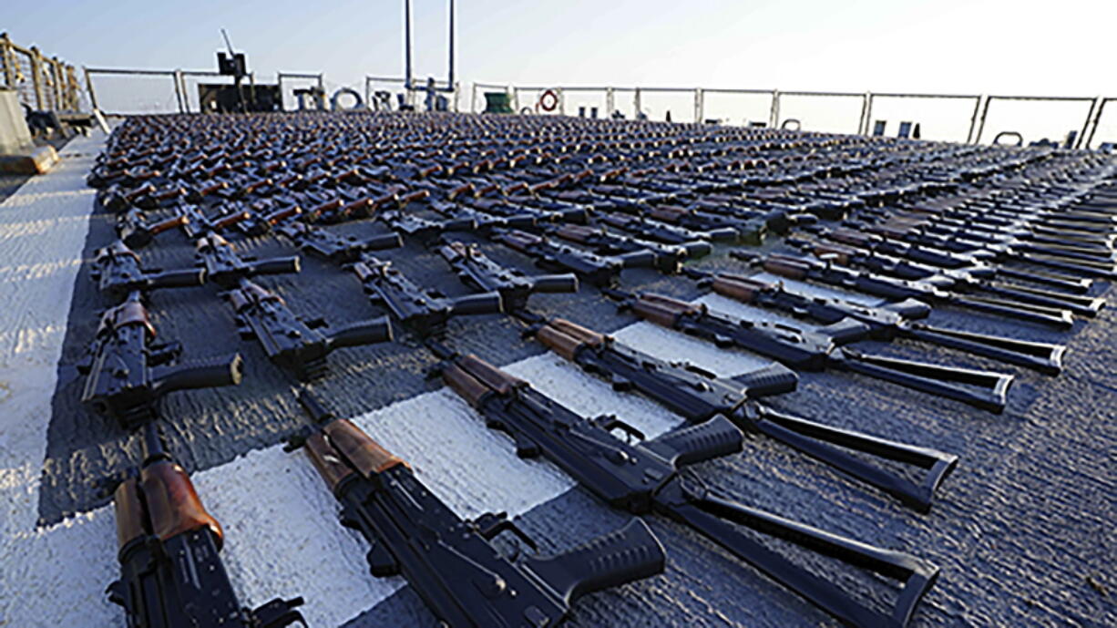 In this photo release by the U.S. Navy, hundreds of AK-47 assault rifles sit on the flight deck of the guided-missile destroyer USS The Sullivans during an inventory process, Jan. 7, 2023. The U.S. Navy has seized over 2,100 assault rifles from a ship in the Gulf of Oman it believes came from Iran and were bound for Yemen's Iran-backed Houthi rebels. (U.S.