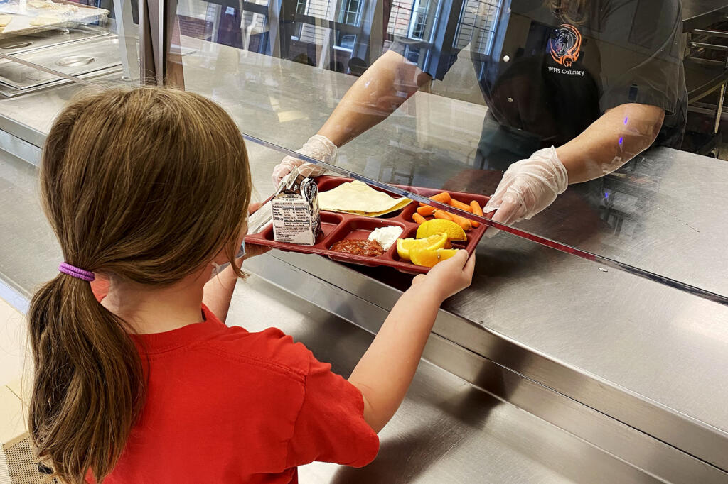 A Washougal School District employee  prepares food for students and employees.