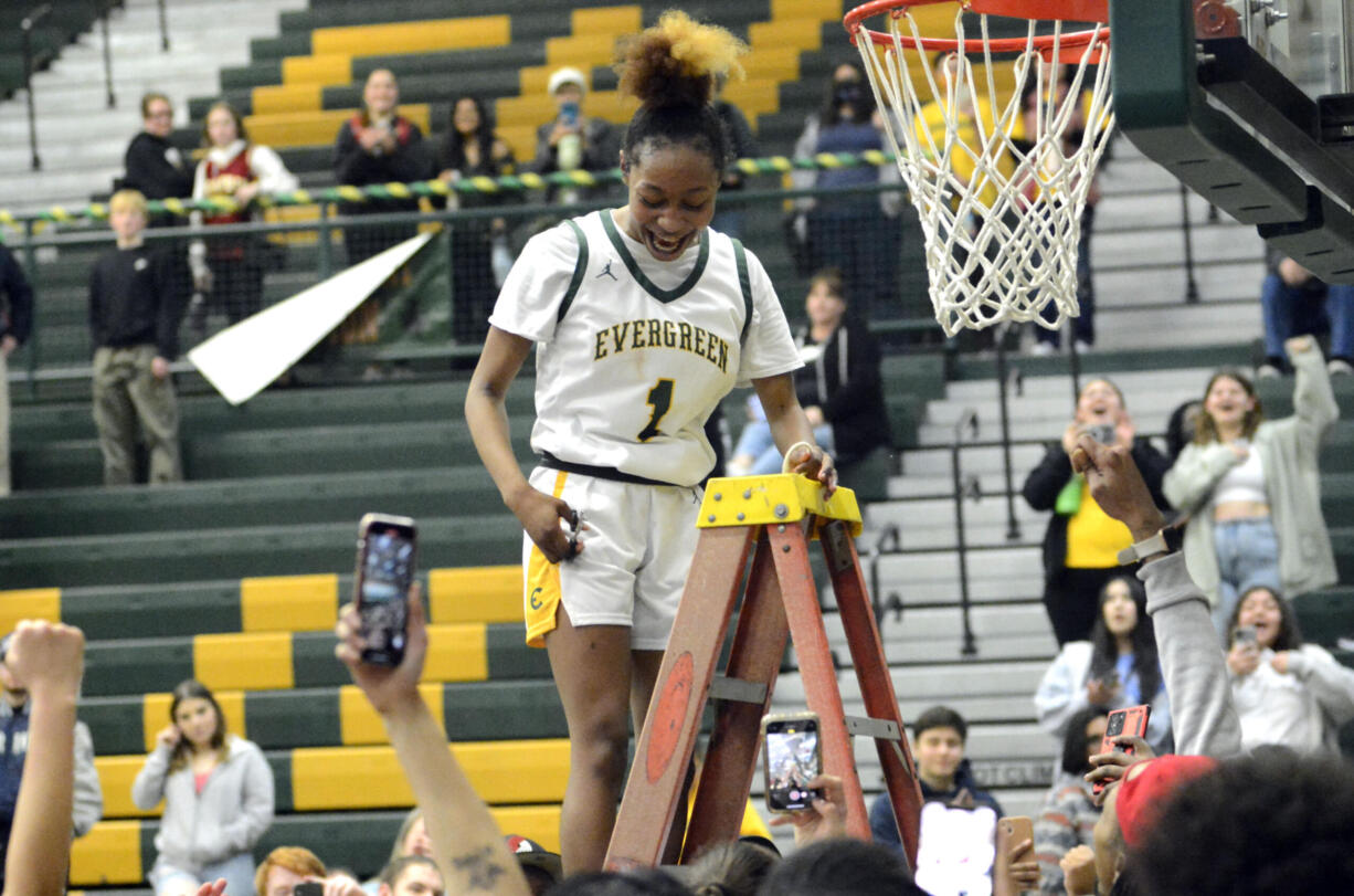 Evergreen senior Lavalerie Lindsey cuts down a piece of the net after the team defeated Prairie to win the 3A Greater St. Helens League girls basketball title on Wednesday, Feb. 1, 2023, at Evergreen High School.