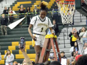 Evergreen senior Lavalerie Lindsey cuts down a piece of the net after the team defeated Prairie to win the 3A Greater St. Helens League girls basketball title on Wednesday, Feb. 1, 2023, at Evergreen High School.