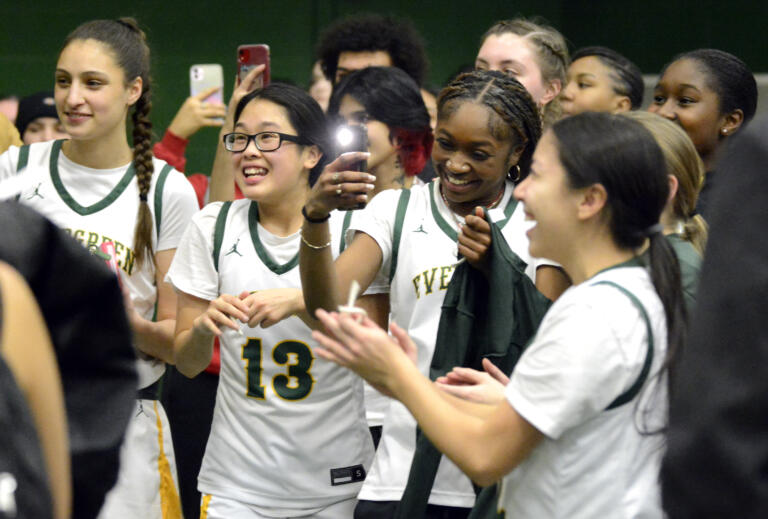 Evergreen players cheer during the team’s net-cutting ceremony to celebrate winning the 3A GSHL girls basketball title on Wednesday, Feb. 1, 2023, at Evergreen High School.