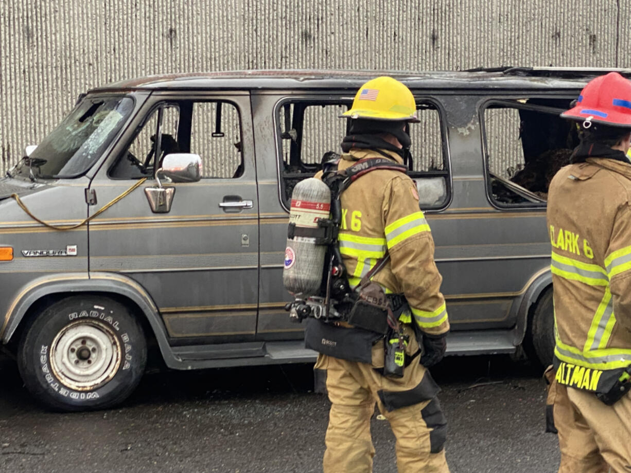 Firefighters respond to a van fire Tuesday morning in the 8400 block of Northeast Eighth Avenue in Hazel Dell. One person was killed and another seriously injured in the blaze.